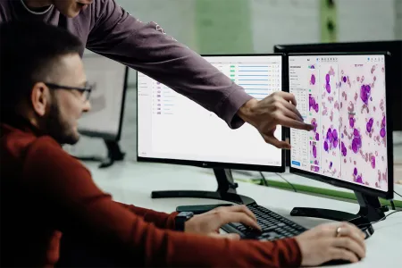 Two doctors analyzing the results of a slide using Cellbytes.