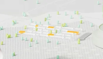 3D render image of a bunch of small green and teal pill shapes hanging out in clusters.